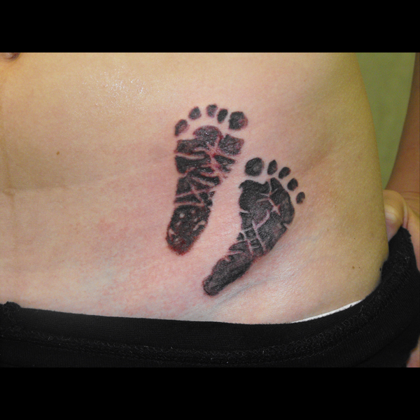 i got the baby's handprints and name added to me. Baby hand print tattoos
